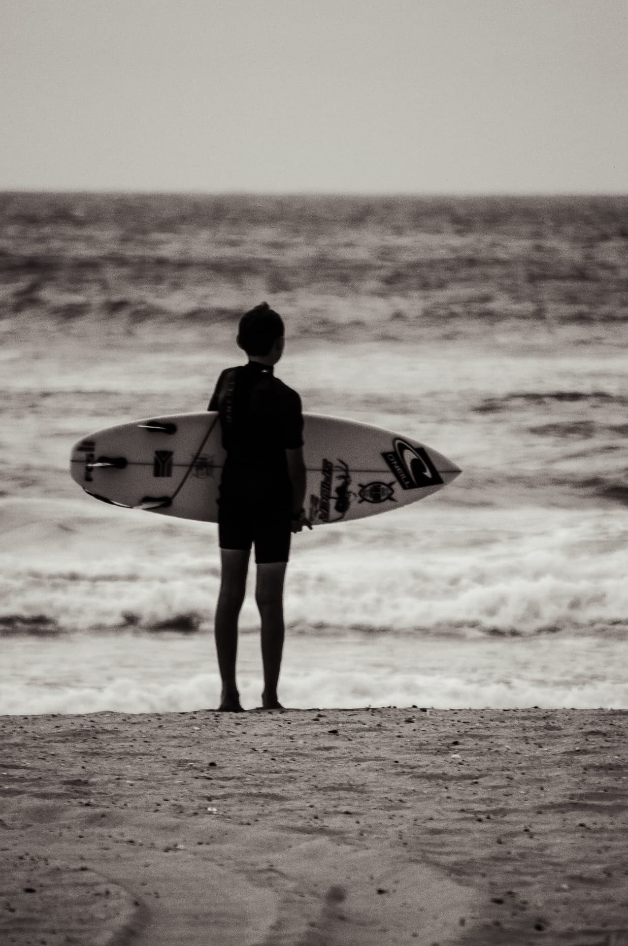 Editorial photography — Awaiting the Perfect Wave personal project, surfer silhouetted against the ocean in monochrome